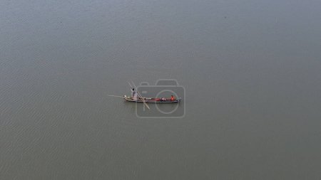 Photo for Aerial view of a fisherman on his boat in the lake - Royalty Free Image