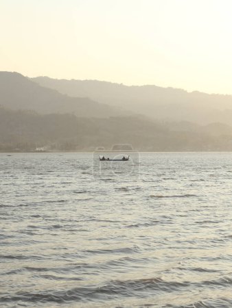 Photo for Silhouette of fisherman on the lake at sunset - Royalty Free Image