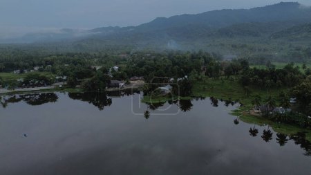 Aerial view of Perintis Lake surrounded by trees