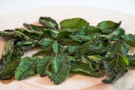 Fresh mint leaves on wooden table. Mint leaves prepared to dry.