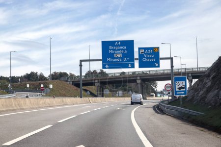Image of section of the A4 motorway, transmontana motorway, Porto, Vila Real, Portugal. Information board, directions. Beautiful day with high clouds.