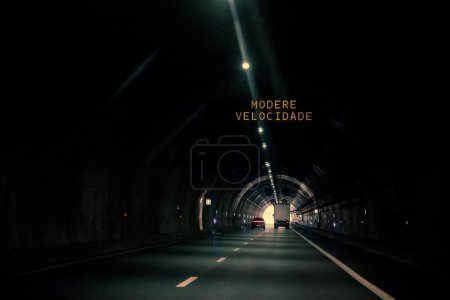 Luminous sign with message for drivers, moderate speed, inside the tunnel. Tunel do Marao is a road tunnel located in Portugal that connects Amarante to Vila Real, crossing the Serra do Marao.