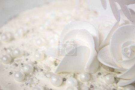 White party cake with white icing and pearls, cake design. Handmade cake made for a special celebratory occasion. Special details.