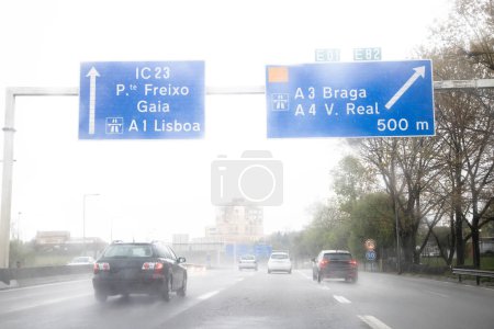 Image of the section of the internal beltway, VCI, Porto, Portugal. Local traffic during a day of bad weather conditions with heavy rain. Information panel, directions.