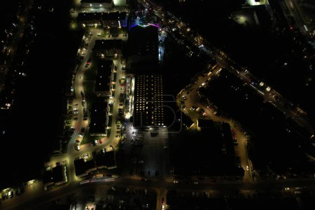 Photo for UK, ENGLAND, LUTON - 20TH JANUARY 2023: Illuminated View English City During Night. Aerial View of Road and Traffic with Businesses at Night. Drone's Camera View - Royalty Free Image
