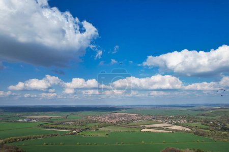 Photo for Aerial View of British Countryside and Paragliders while they are Flying High in the Sky - Royalty Free Image