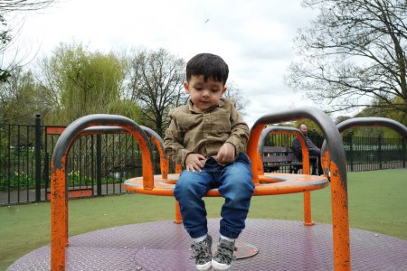 Photo for Cute Asian Pakistani Baby Boy is Having Fun at Wardown Public Park at Luton Town of England UK - Royalty Free Image
