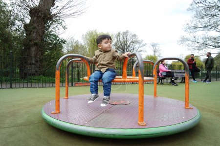Photo for Cute Asian Pakistani Baby Boy is Having Fun at Wardown Public Park at Luton Town of England UK - Royalty Free Image