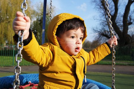 Photo for Cute Asian Pakistani Baby Enjoying The Beautiful Sunny Day at Lewsey Public Park - Royalty Free Image