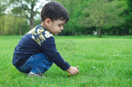 Photo for Luton, England, United Kingdom - May 9, 2023: cute little boy in spring park - Royalty Free Image