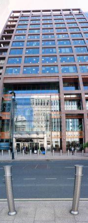 Photo for Low Angle Vertical Panoramic View of Canary Wharf Central London City with Tall Buildings, Road, People at Most Expensive Area of London City of England UK. The Footage Was Captured on 08-June-2023 - Royalty Free Image