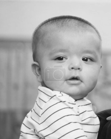Photo for Cute Asian Pakistani Baby Boy is Posing in the Home Garden During Cloudy Day over Luton, England UK. Image Was Captured on July 23rd, 2023 - Royalty Free Image
