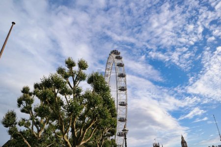 Photo for Beautiful Low Angle View of London Eye, from Historical Big Ben Clock Tower river Thames, at Westminster Central London, England Great Britain, UK. Image Captured During Cloudy Day of August 2nd, 2023 - Royalty Free Image