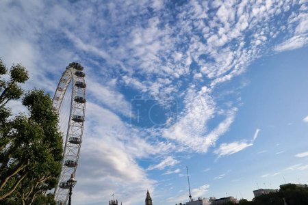 Photo for Beautiful Low Angle View of London Eye, from Historical Big Ben Clock Tower river Thames, at Westminster Central London, England Great Britain, UK. Image Captured During Cloudy Day of August 2nd, 2023 - Royalty Free Image