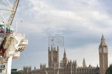 Photo for Beautiful Low Angle View of Historical Big Ben Clock Tower from river Thames and London Eye, Westminster Central London, England Great Britain, UK. Image Captured During Cloudy Day of August 2nd, 2023 - Royalty Free Image