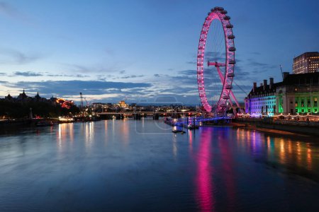 Photo for Most Beautiful Footage of Illuminated London eye from River Thames Westminster, Big Ben clock Tower at After Sunset Night. England Great Britain,  Footage Was Captured on Aug 02nd, 2023 After Sunset. - Royalty Free Image