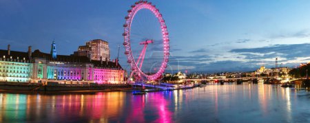 Photo for Most Beautiful Footage of Illuminated London eye from River Thames Westminster, Big Ben clock Tower at After Sunset Night. England Great Britain,  Footage Was Captured on Aug 02nd, 2023 During Sunset. - Royalty Free Image