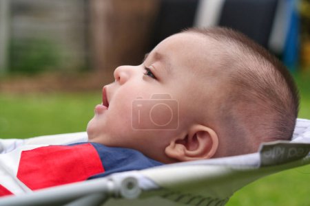 Photo for Close Up Shot of Cute Asian Pakistani 4 Months Old Baby Boy, Who is Enjoying at Home Garden at Luton City of England UK. Image Was Captured on July 23rd, 2023 - Royalty Free Image