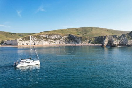 Photo for Gorgeous High Angle View of People are Enjoying the Hot British Weather on Boats and Swimming in Ocean Beach of Durdle Door Sea View Waters of England Great Britain. Image Captured on Sep 9th 2023 - Royalty Free Image