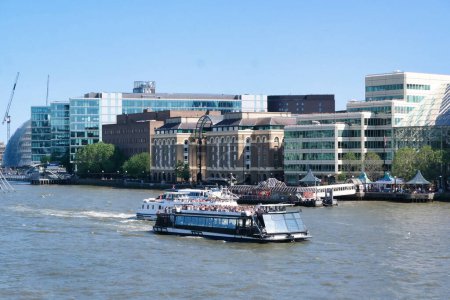 Photo for Low Angle View of Boat over River Thames Waters at London Bridge, Capital City of England Great Britain. The River Thames is Passing Through The Heart of Central London City's Most Attractive Tourist Attractions. The Image Was Captured June 4th, 2023 - Royalty Free Image