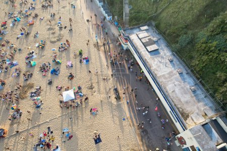 Photo for Aerial View of Many People are Enjoying Hot Summer's Day over England at Bournemouth Sandy Beach During Their Holidays. Most Beautiful Tourist Attraction Captured with Drone's Camera on Sep 9th, 2023, England UK - Royalty Free Image
