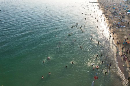 Photo for Aerial View of Many People are Enjoying Hot Summer's Day over England at Bournemouth Sandy Beach During Their Holidays. Most Beautiful Tourist Attraction Captured with Drone's Camera on Sep 9th, 2023, England UK - Royalty Free Image