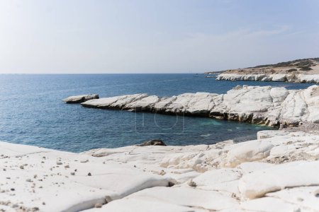 view of coastline and landmark big white chalk rock at Governors beach,Limassol, Cyprus. Steep stone cliffs and deep blue sea