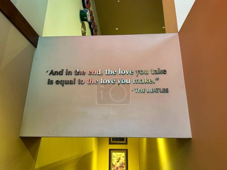 Photo for Las Vegas, Nevada - March 13, 2023 - The Beatles quote "And in the end, the love you take is equal to the love you make." At the Hard Rock Cafe - Royalty Free Image