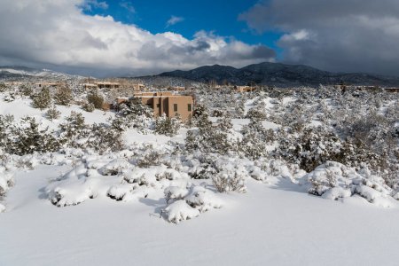 Adobe houses in a snow-covered winter landscape in Santa Fe, New Mexico