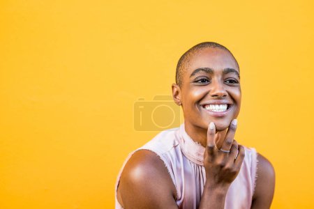 Foto de De cerca y retrato de una joven y hermosa mujer afroamericana mirando a la cámara sonriendo y abriendo los ojos - alegre chica bonita disfrutando - Imagen libre de derechos