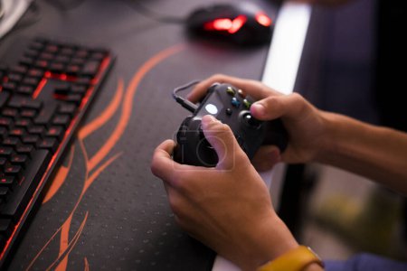 Photo for Close up of hands playing video games and holding a controller - type of hobby and entertainment for all people - indoor and at home concept - Royalty Free Image