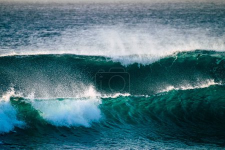 close up of beautiful and big blue and green waves breaking - pacific or Atlantic ocean - blue sea and great place to surf  