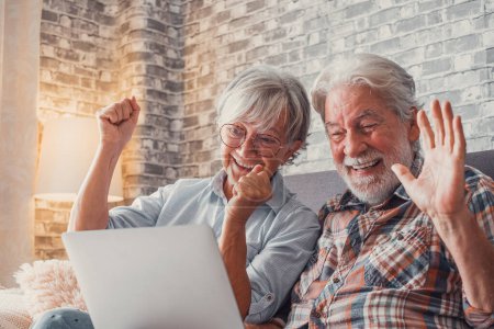 Portrait of mature people shocked for a result. Old couple reacting to an unexpected new on their laptop. Enjoying at home together. 
