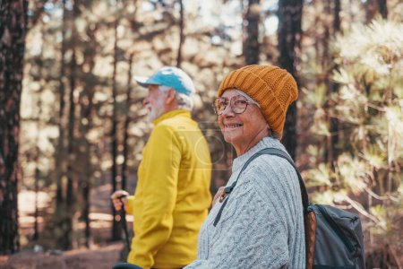 Photo for Portrait close up head shot of one cheerful smiling middle age woman walking with her husband enjoying free time and nature. Active beautiful seniors in love together at sunny day. - Royalty Free Image