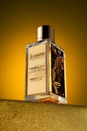 Photo for Jasmins Marzipane Perfume standing in a heroic perspective on a gold table and on a gold background - Royalty Free Image