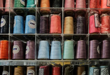 Photo for Multi-colored threads for household and industrial sewing machines and overlockers.Sewing threads. - Royalty Free Image