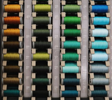 Photo for Multi-colored threads for household and industrial sewing machines and overlockers.Sewing threads. - Royalty Free Image