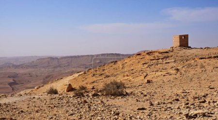 Photo for Makhtesh Ramon is a geological feature of the Israeli Negev Desert. Situated approximately 85 km south of the city of Beersheba, this landform represents the world's largest erosion circus - Royalty Free Image