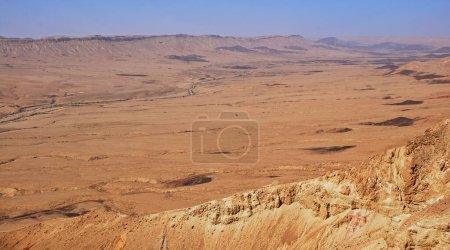 Photo for Makhtesh Ramon is a geological feature of the Israeli Negev Desert. Situated approximately 85 km south of the city of Beersheba, this landform represents the world's largest erosion circus - Royalty Free Image