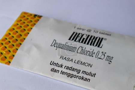 Photo for Jakarta, Indonesia in December 2022. Isolated white photo of Degirol Dequalinium Chloride 0.25 mg 1 strip containing 10 tablets. This medicine is used to treat sore throat, inflammation or infection of the mouth and throat, as well as to prevent cold - Royalty Free Image