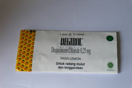 Photo for Jakarta, Indonesia in December 2022. Isolated white photo of Degirol Dequalinium Chloride 0.25 mg 1 strip containing 10 tablets. This medicine is used to treat sore throat, inflammation or infection of the mouth and throat, as well as to prevent cold - Royalty Free Image