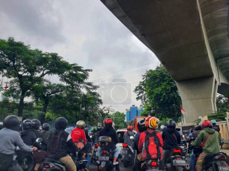 Photo for Jakarta, Indonesia in July 2022. There is a traffic jam under the Becakayu Toll Road, where motorbikes are stopping and moving slowly. - Royalty Free Image