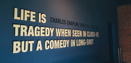 Photo for Jakarta, Indonesia in March 2019. One corner of a movie theater that has a quote from Charles Chaplin on the wall with the words Life is a tragedy when seen in close up, but a comedy in long shot. - Royalty Free Image