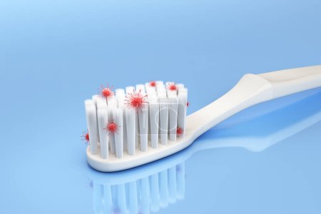 Téléchargez les photos : White toothbrush. Microscopic view Uncleaned toothbrush bristles contain bacteria, fungi, virus, red stains on blue background. Resulting in tooth decay, swollen gums and bad breath. 3D Illustration. - en image libre de droit
