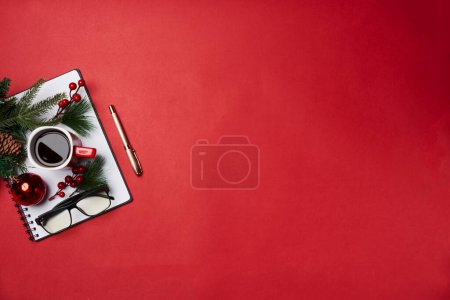 Photo for A cup of coffee and christmas decorations on a red background with copy - space for your own text or message - Royalty Free Image