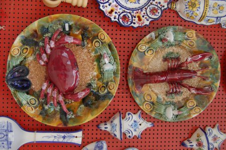Photo for Collection of colorful Portuguese ceramic pottery, local craft products from Portugal. Ceramic plates display in Portugal. Colorful of vintage ceramic plates in Sagres, Portugal - Royalty Free Image