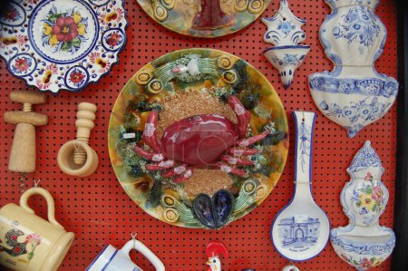 Photo for Collection of colorful Portuguese ceramic pottery, local craft products from Portugal. Ceramic plates display in Portugal. Colorful of vintage ceramic plates in Sagres, Portugal - Royalty Free Image