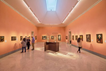 Photo for MADRID SPAIN - July 31, 2023: Exhibition room of the Museo Nacional Thyssen-Bornemisza with people inside observing the works. - Royalty Free Image