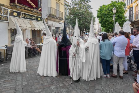 Photo for Jerez de la Frontera, Spain - September 8, 2023: Brotherhood of Nazarenes of Jerez de la Frontera tunics with tunics on the street - Royalty Free Image