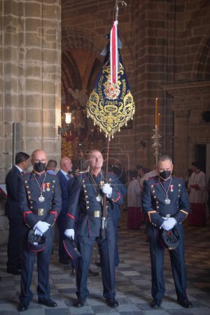 Photo for Jerez de la Frontera, Spain - February 16, 2024: Officers holding a banner during holy week in the cathedral of jerez, spain. - Royalty Free Image